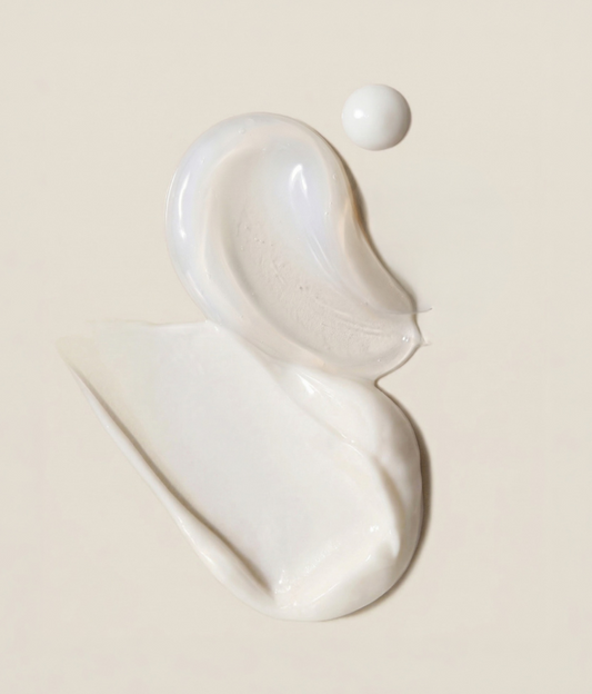 Lancer skincare set featuring a blue serum bottle with a white dropper, a blue jar of ultra rich barber cream with a silver lid, and a clear gua sha face massage tool on a white background.