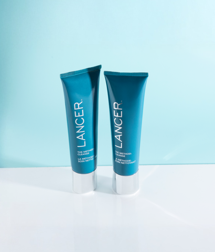 Two blue Lancer skincare tubes on a light blue background-Lancer Skincare