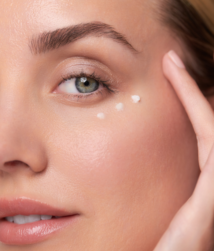 Close-up of a woman's face with a product applied to her cheek.-Lancer Skincare
