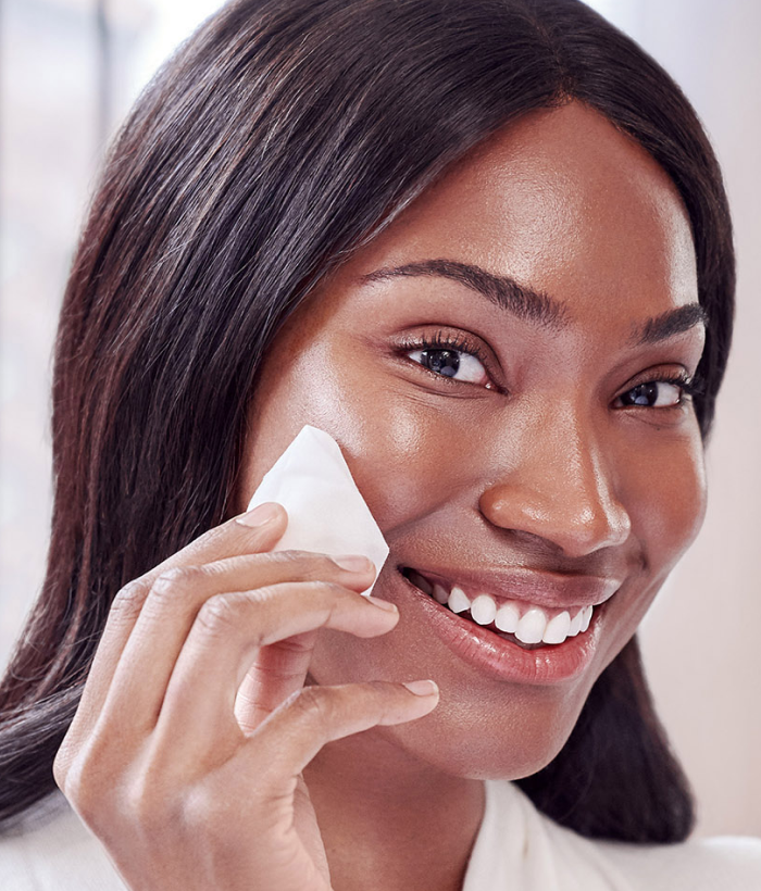Woman wiping face with a white face pad-Lancer Skincare