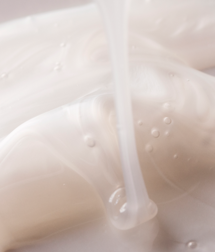 Close-up of a white creamy substance with a light background