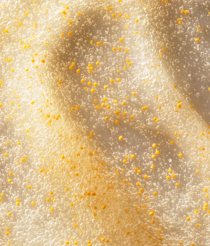 Close-up of a textured face wash with small yellow beads-Lancer Skincare
