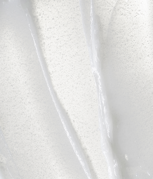 Blue tube of Lancer skincare product on a white background