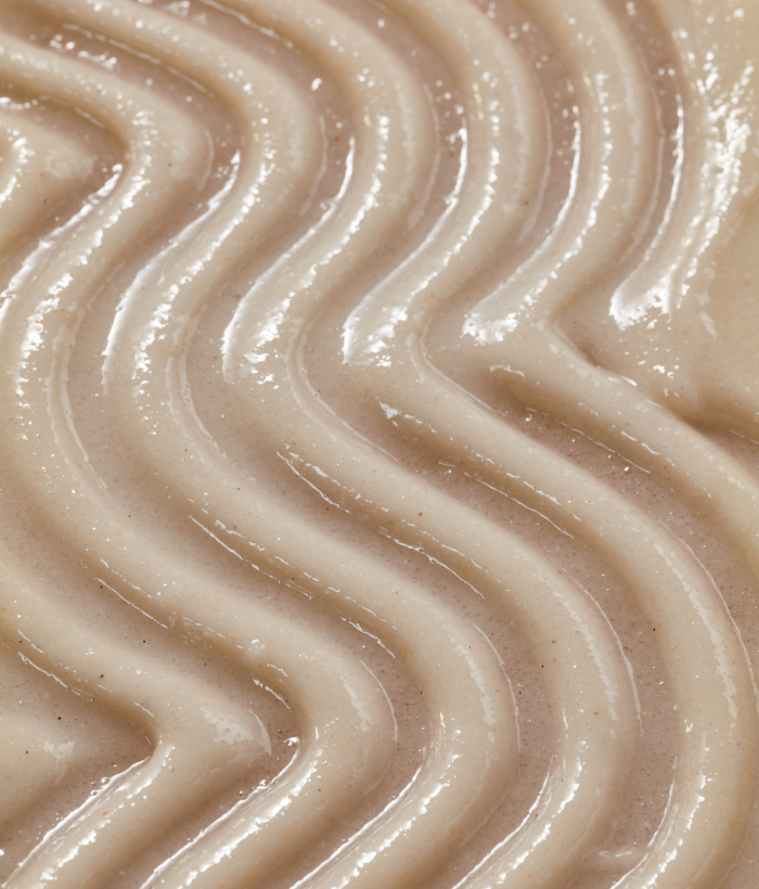 Close-up of smooth, creamy beige body exfoliator texture-Lancer Skincare