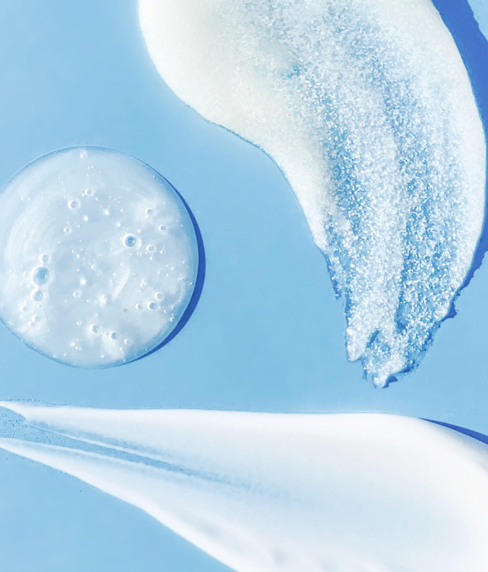 Close-up of white cream or gel with bubbles on a blue background-Lancer Skincare